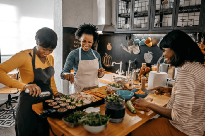 women making food in a kitchen holiday ready